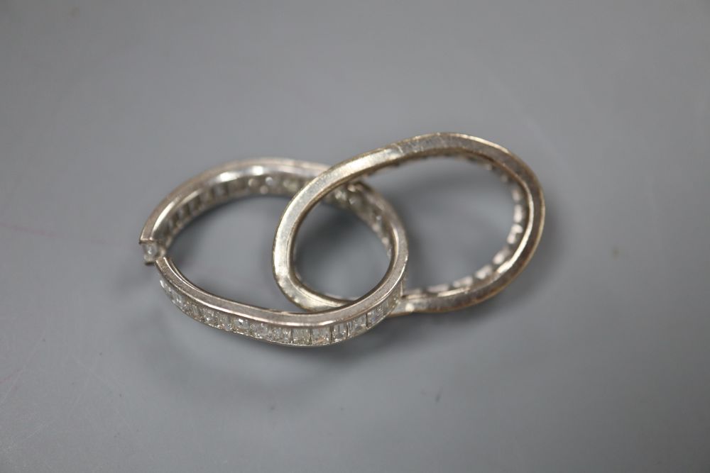 Two white metal and baguette cut diamond set full eternity rings, both very mis-shapen and one shank has been cut, gross 7.8 grams.